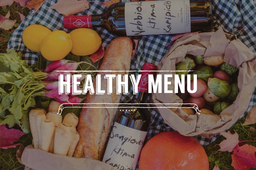 fruits and baguette bread with bottle of wine